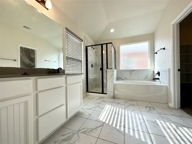 a bathroom with a bathtub and a shower