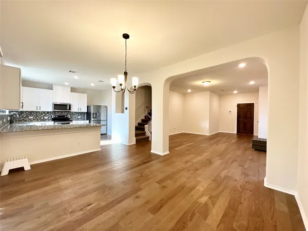 a view of a kitchen with a sink and a wooden floor
