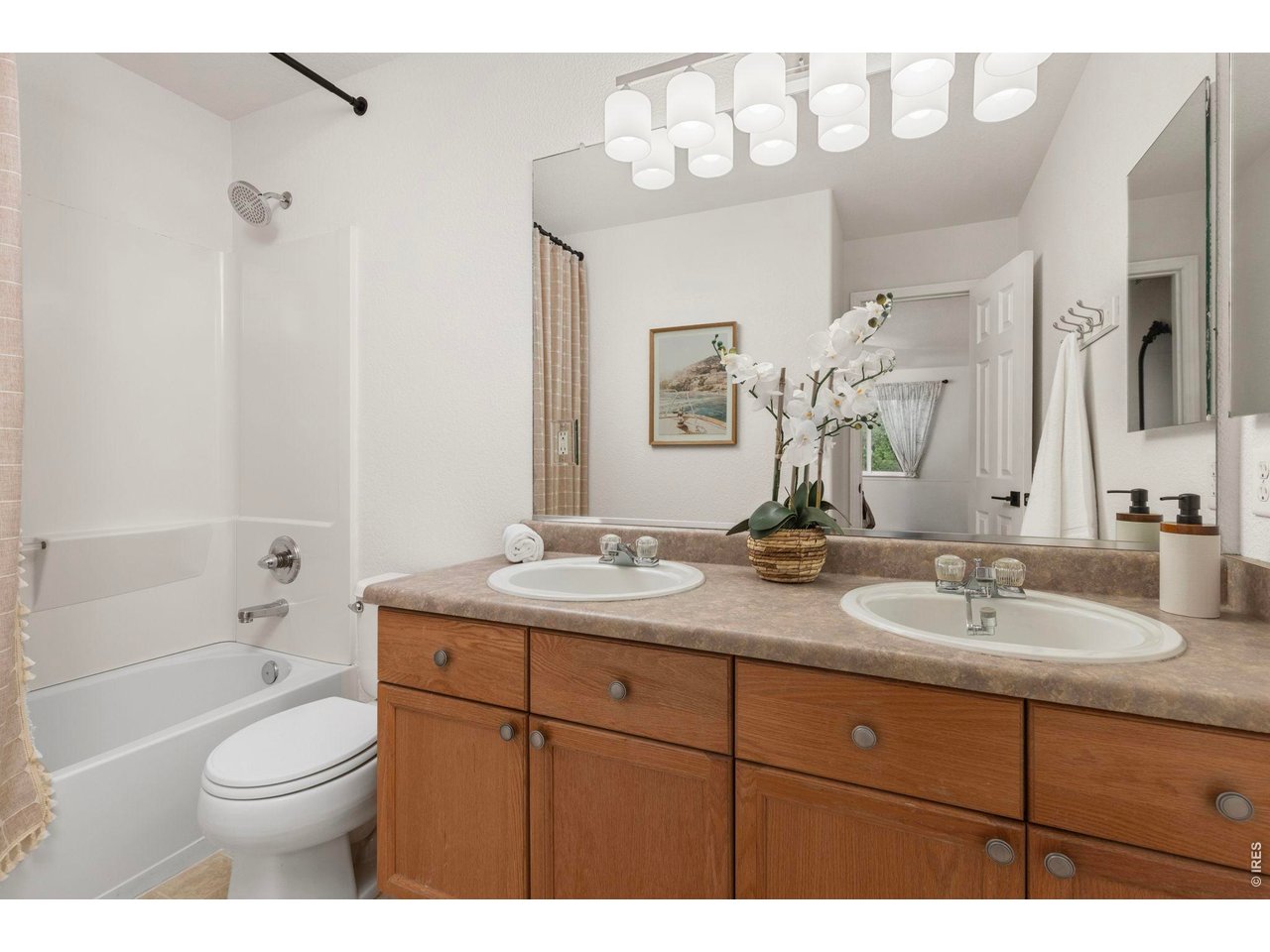 6531 St Vrain Ranch Boulevard Firestone, CO 80504 - Photo 18 of 30 a bathroom with a granite countertop sink mirror vanity and toilet