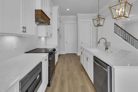 a view of an empty room with wooden floor and closet
