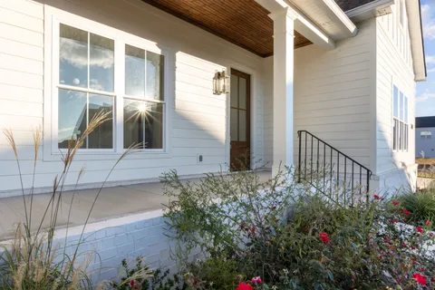 a view of a house with a flower garden