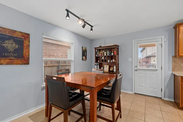a view of a dining room with furniture and a window