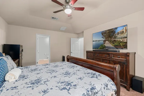 a bedroom with a bed and a flat screen tv