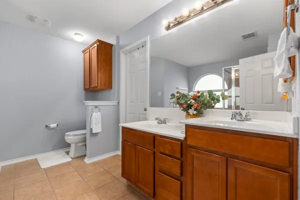 a bathroom with a toilet sink and mirror