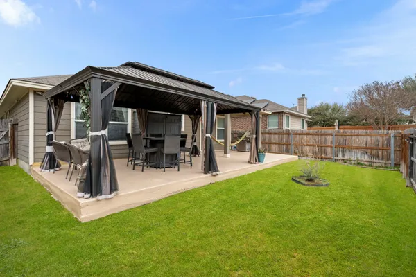 a view of a house with a yard and sitting area