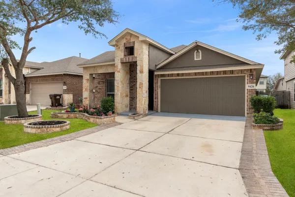 a front view of a house with a yard and garage