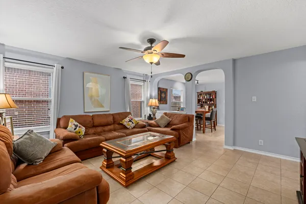 a living room with furniture and a chandelier