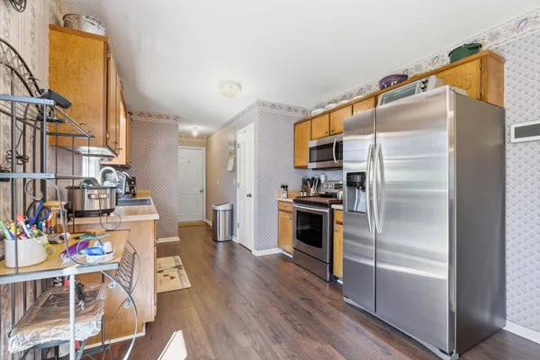 a kitchen with stainless steel appliances a refrigerator and a stove top oven