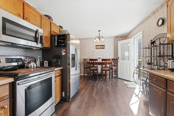 a kitchen with stainless steel appliances granite countertop a stove and cabinets