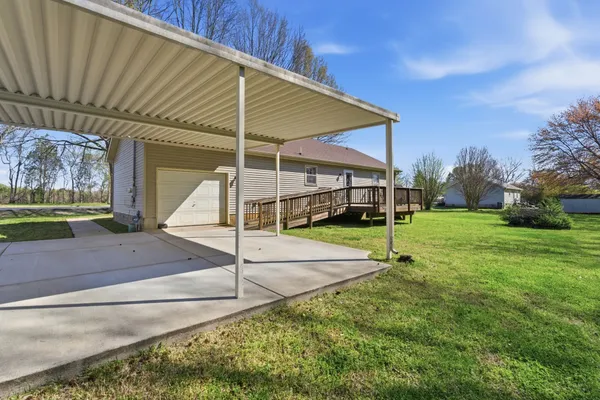 a view of a house with a backyard