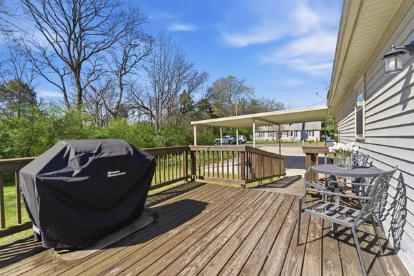 a view of balcony with wooden floor and outdoor seating