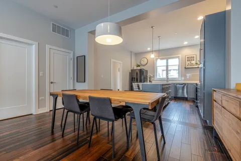 a dining room with furniture and wooden floor