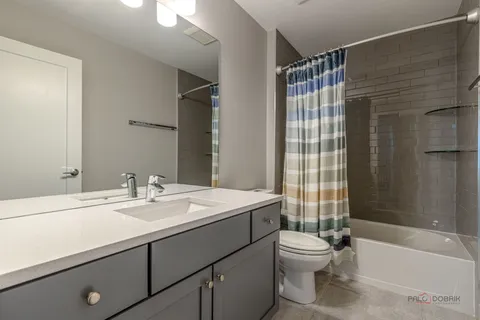 a bathroom with a sink toilet tub and shower