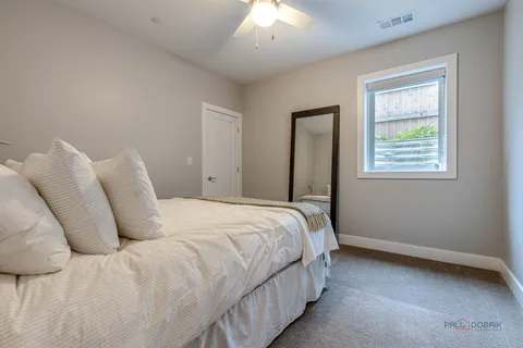 a bedroom with a bed and a window