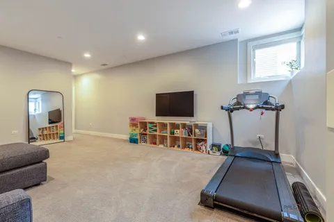 a room with gym equipment and a flat screen tv