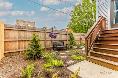 a view of a backyard with plants and a patio