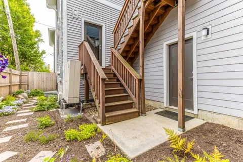 a view of a house with backyard and deck