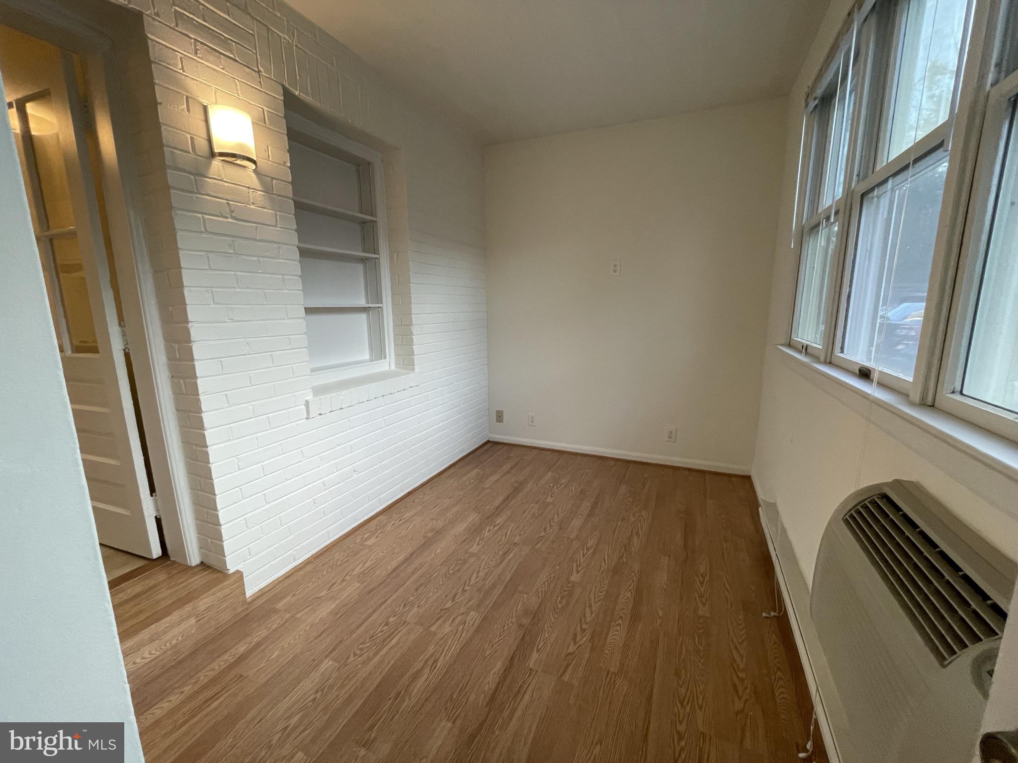 2229 40th Place Northwest, Unit 1 Washington, DC 20007 - Photo 11 of 16 a view of an empty room with wooden floor and a window