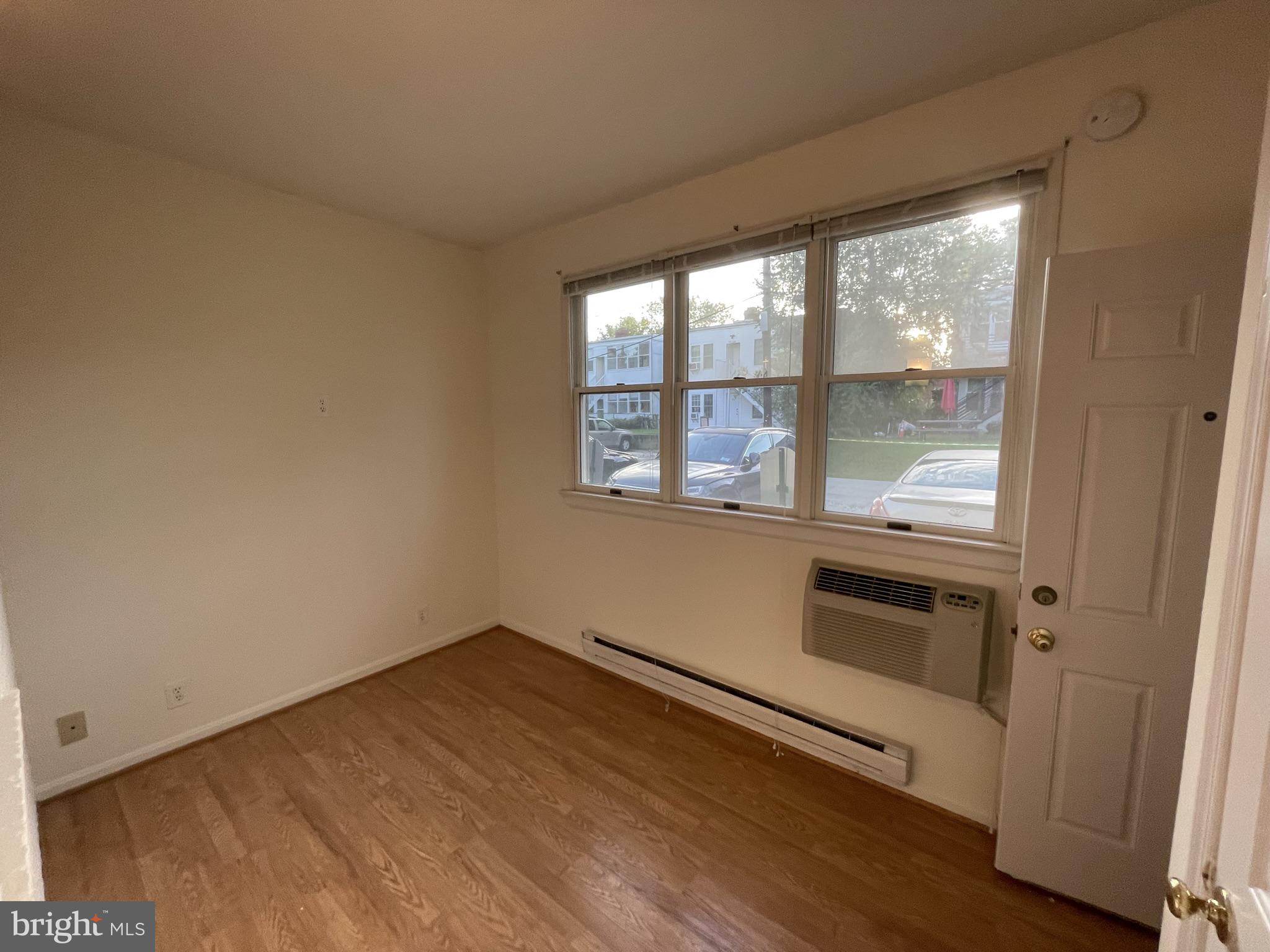 2229 40th Place Northwest, Unit 1 Washington, DC 20007 - Photo 12 of 16 an empty room with wooden floor and windows
