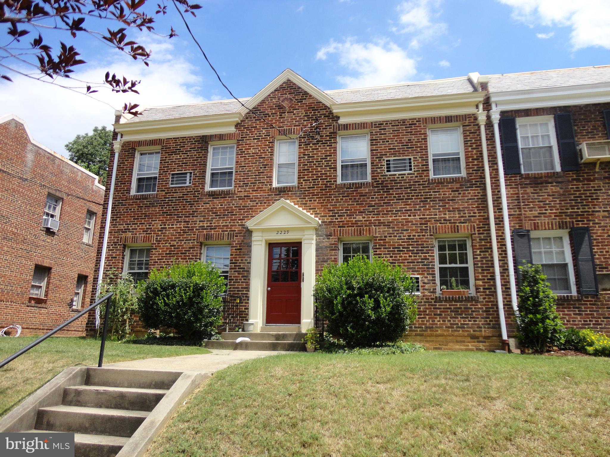 2229 40th Place Northwest, Unit 1 Washington, DC 20007 - Photo 13 of 16 a front view of a house with a yard