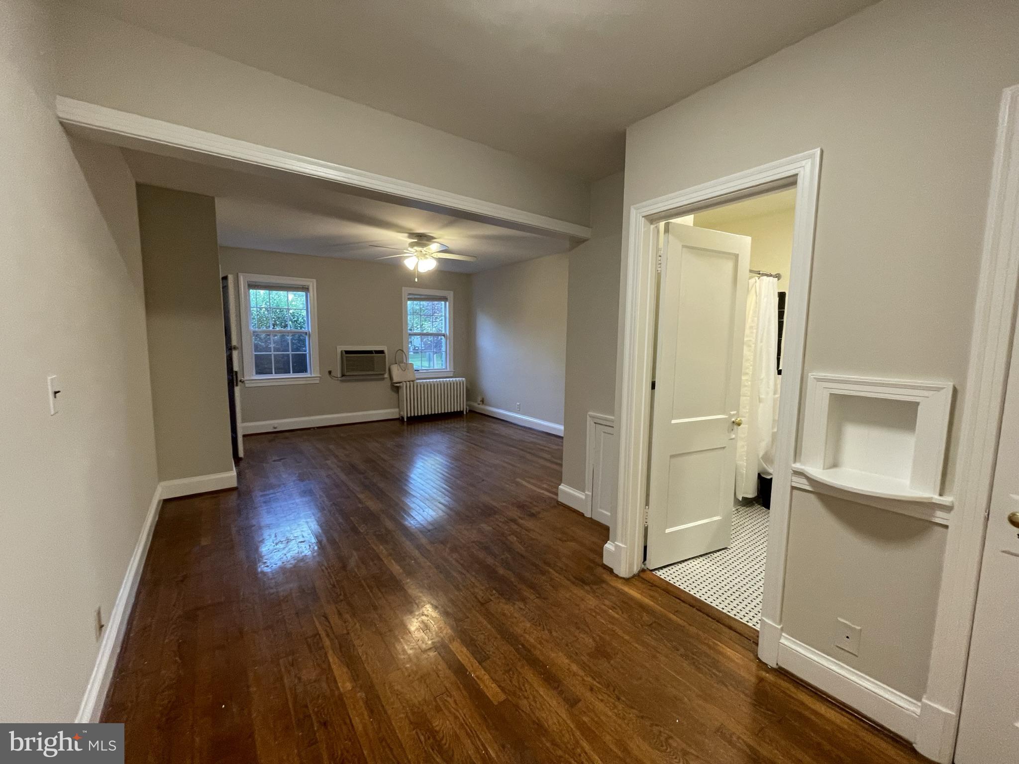 2229 40th Place Northwest, Unit 1 Washington, DC 20007 - Photo 2 of 16 a view of a hallway with wooden floor and a living room