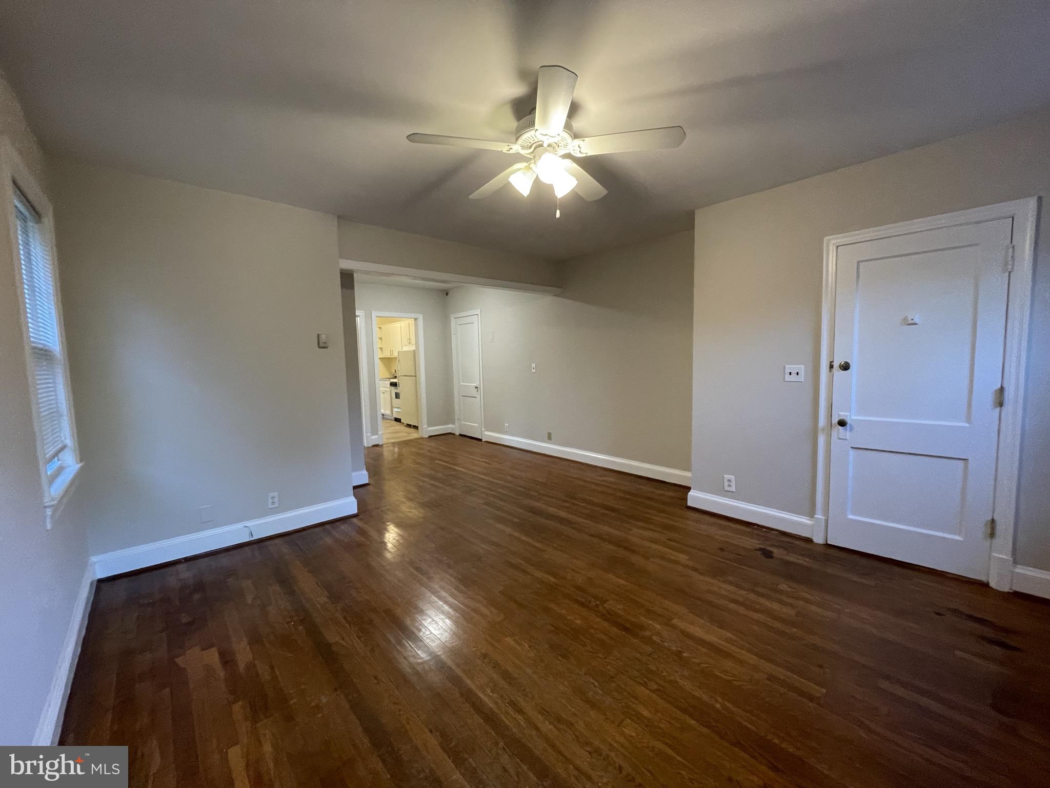 2229 40th Place Northwest, Unit 1 Washington, DC 20007 - Photo 3 of 16 wooden floor in an empty room with a chandelier fan