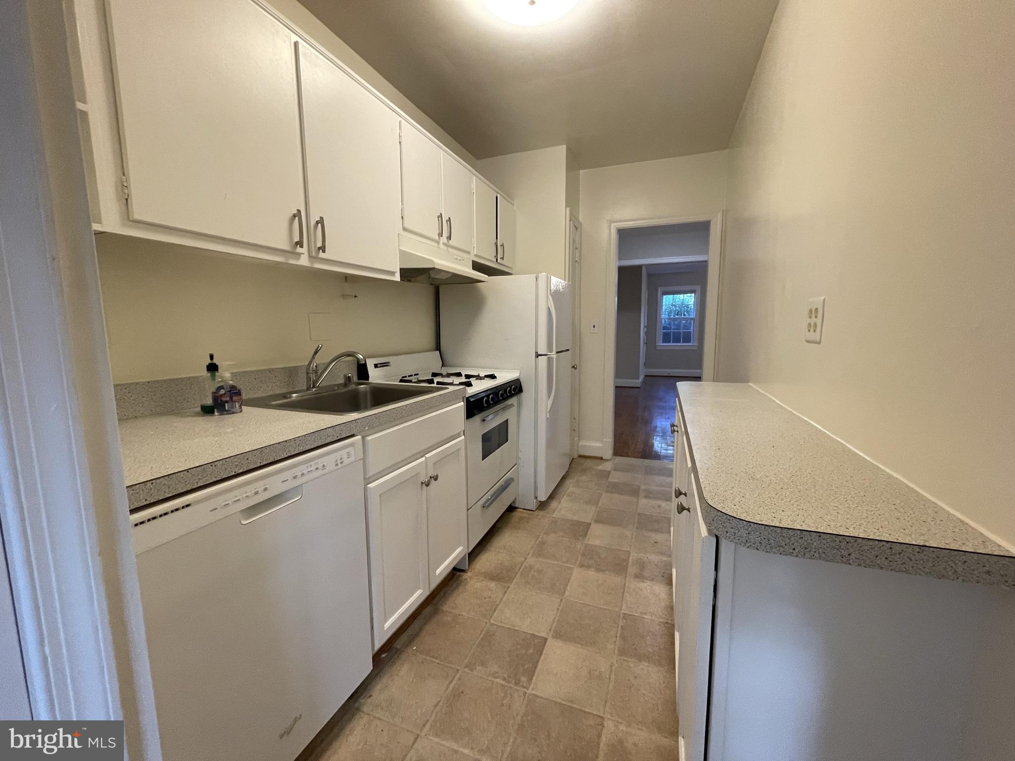 2229 40th Place Northwest, Unit 1 Washington, DC 20007 - Photo 5 of 16 a kitchen with cabinets a sink and appliances