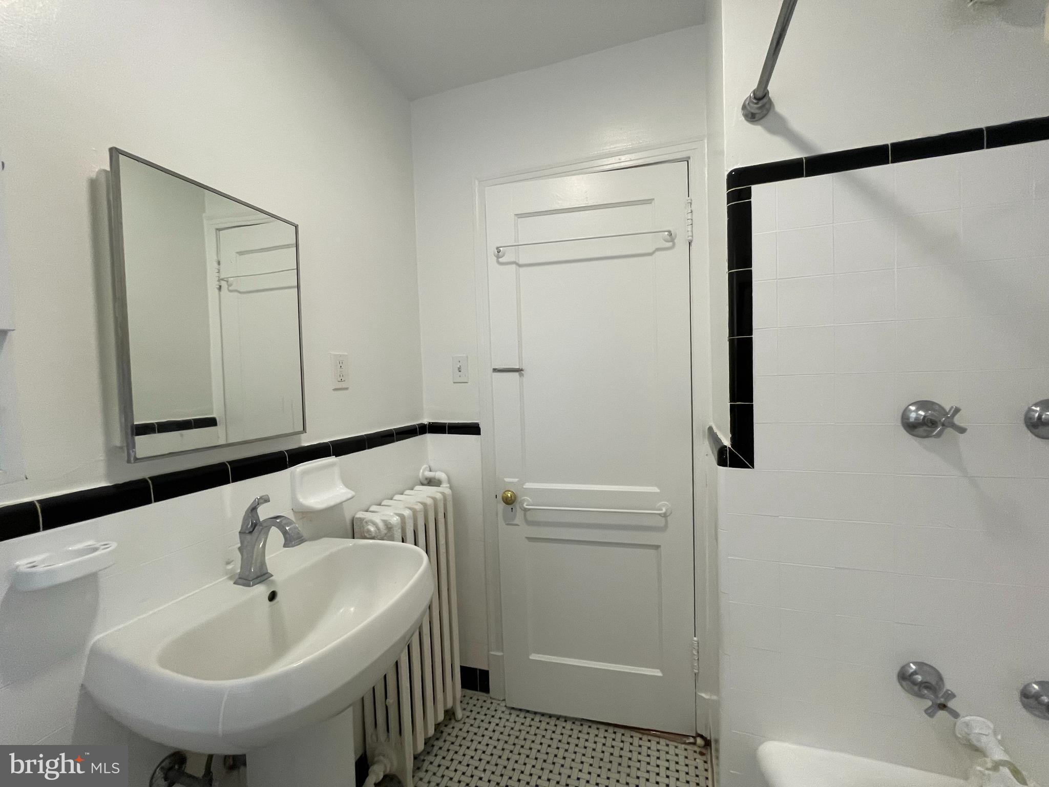 2229 40th Place Northwest, Unit 1 Washington, DC 20007 - Photo 6 of 16 a bathroom with a sink a toilet and shower