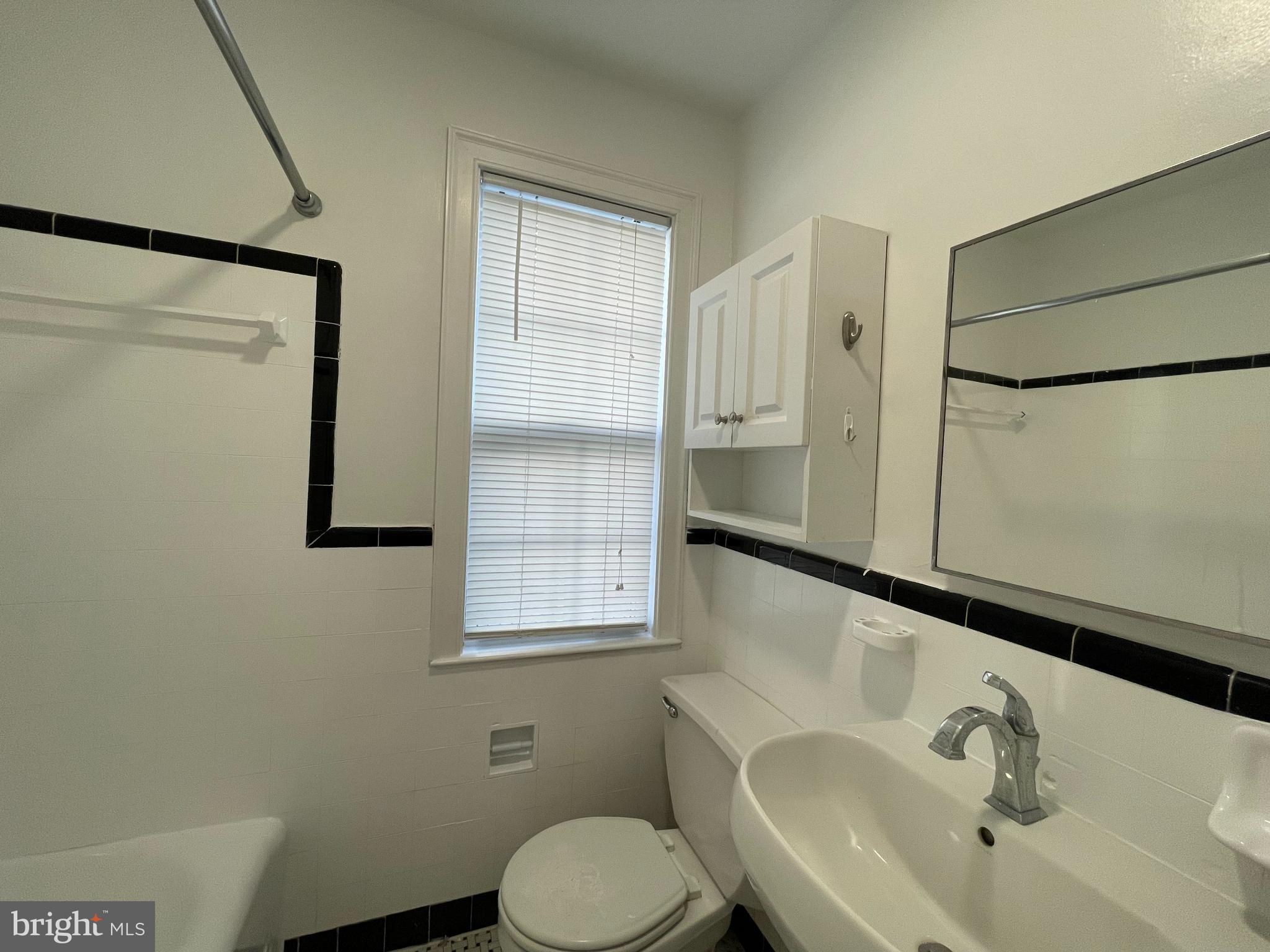 2229 40th Place Northwest, Unit 1 Washington, DC 20007 - Photo 7 of 16 a bathroom with a sink toilet and mirror