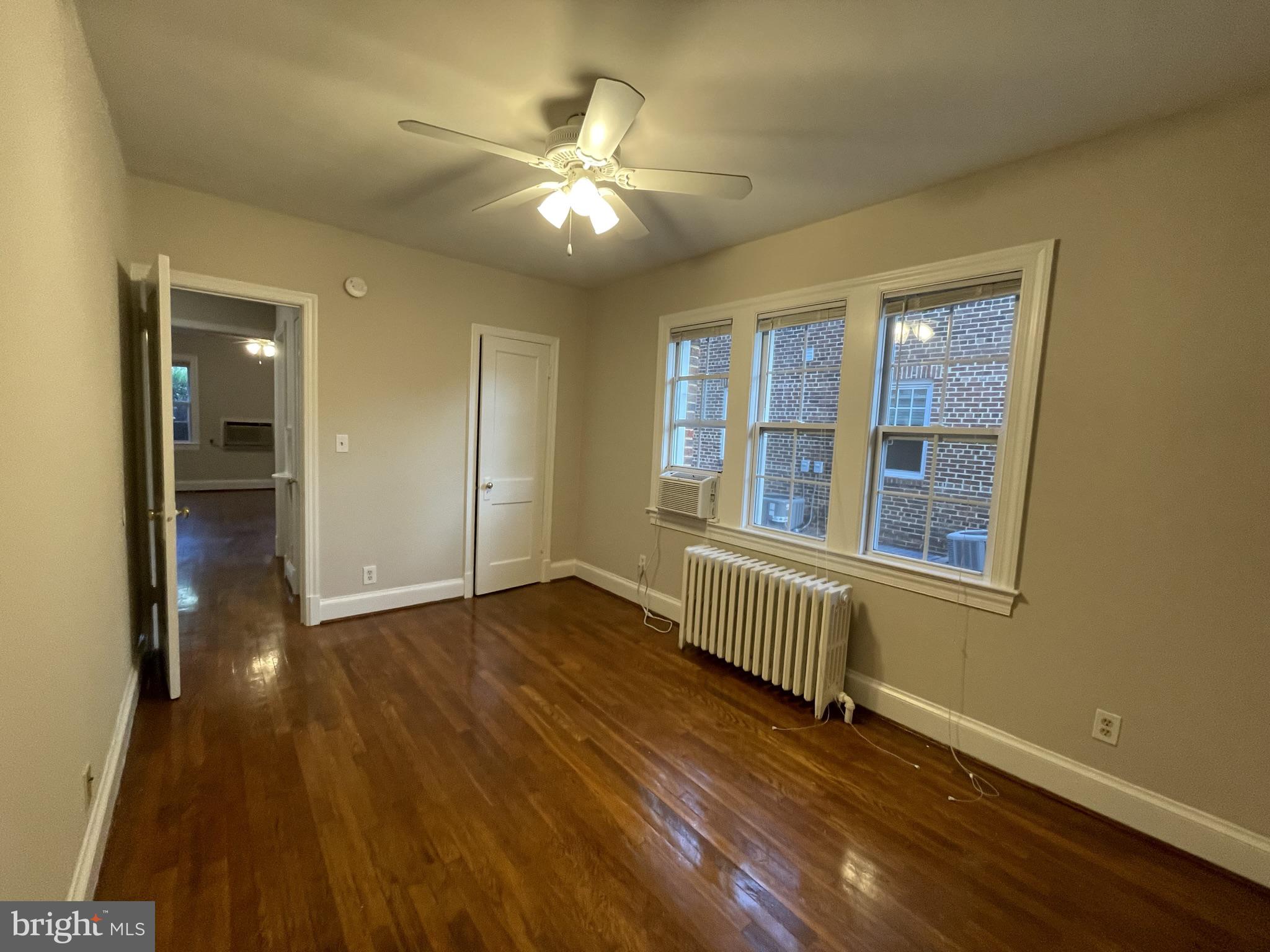 2229 40th Place Northwest, Unit 1 Washington, DC 20007 - Photo 8 of 16 an empty room with wooden floor and windows