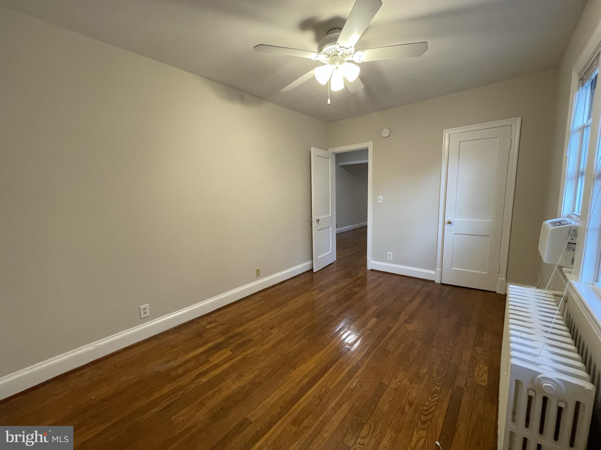 2229 40th Place Northwest, Unit 1 Washington, DC 20007 - Photo 9 of 16 wooden floor in an empty room with a window