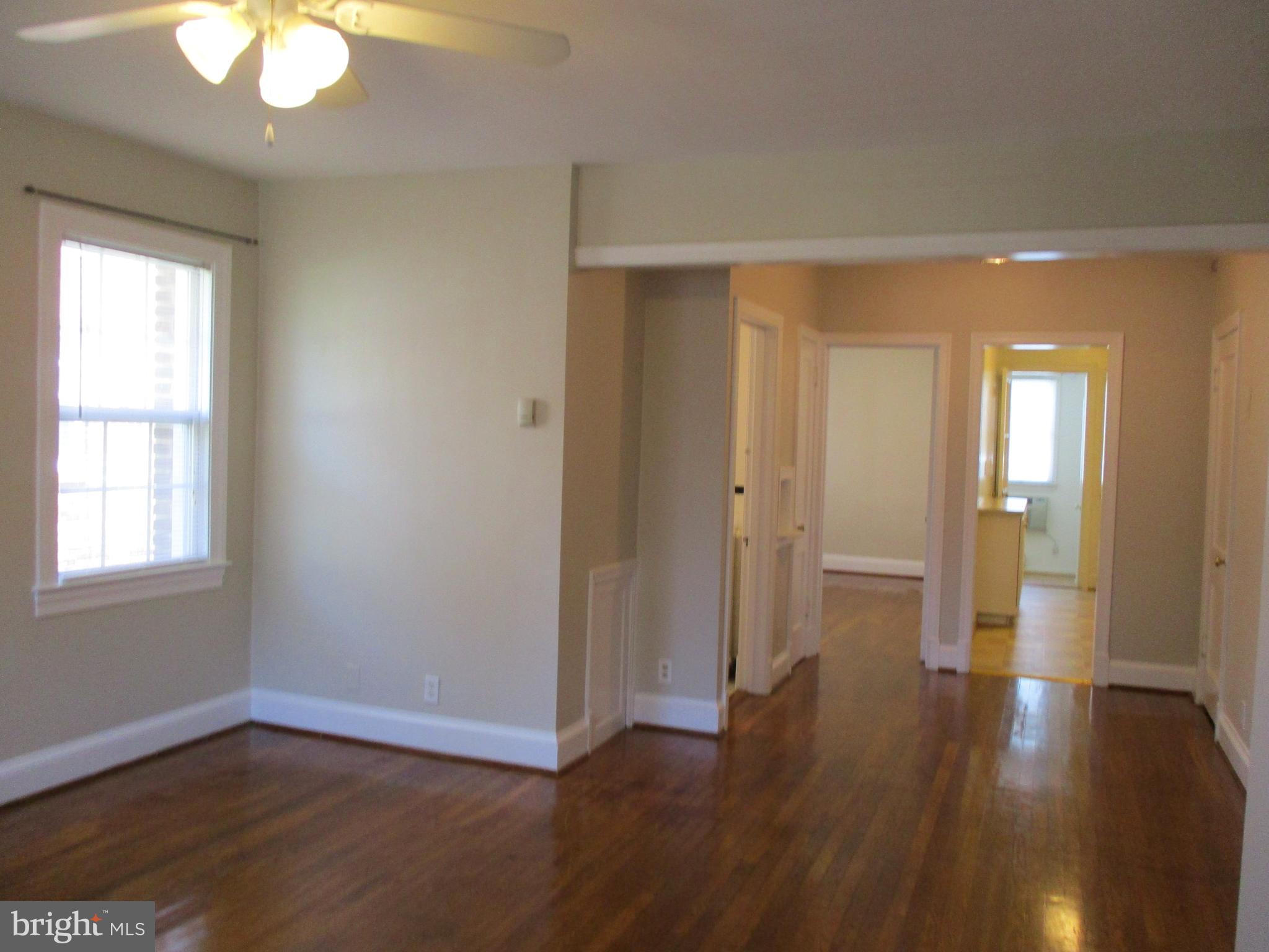 2229 40th Place Northwest, Unit 1 Washington, DC 20007 - Photo 10 of 16 an empty room with wooden floor and windows