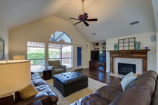 a living room with furniture fireplace and flat screen tv