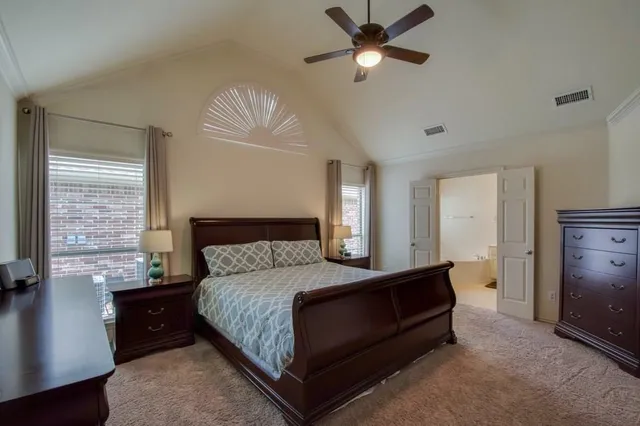 a bedroom with a bed and a chandelier