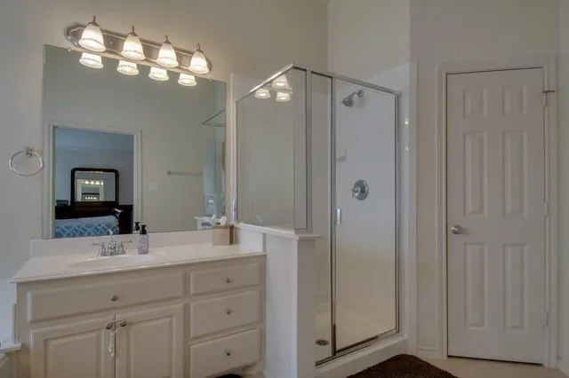 a bathroom with double vanity sink and a mirror