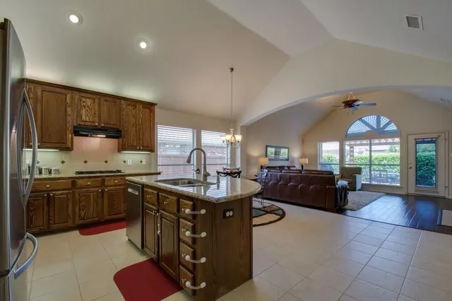 a kitchen with sink stove and cabinets
