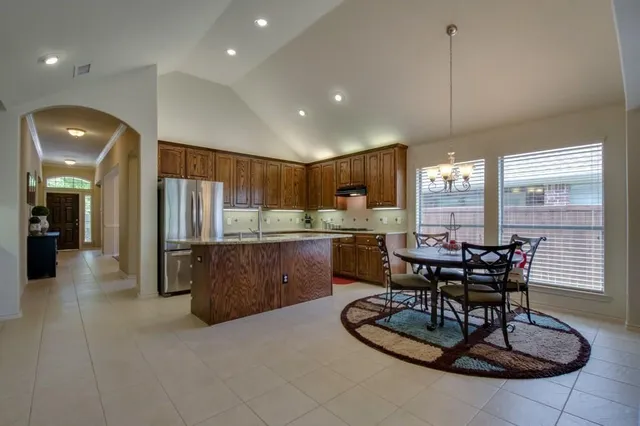 a kitchen with a table and chairs