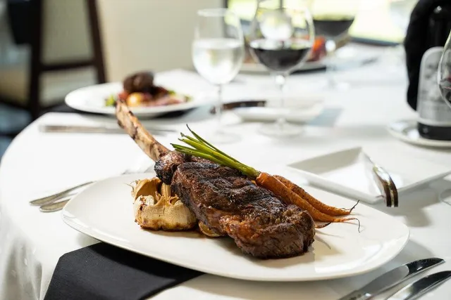 a dining table with chairs and window