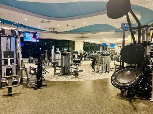 a room with gym equipment and mirror