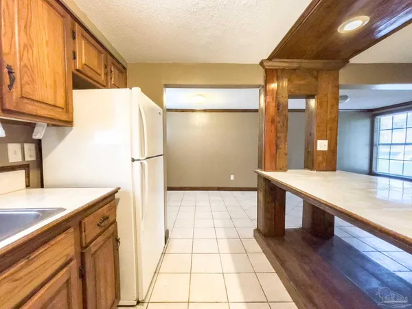 a kitchen with stainless steel appliances granite countertop a sink and a refrigerator