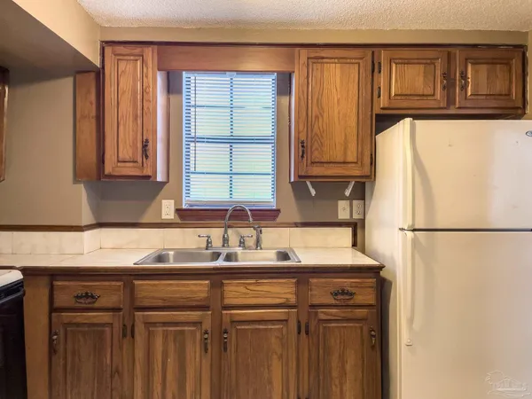 a kitchen with a refrigerator and a sink