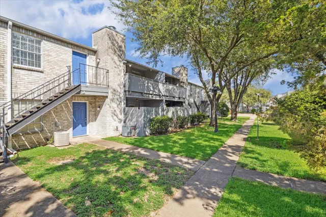 a view of a house with a yard and tree s