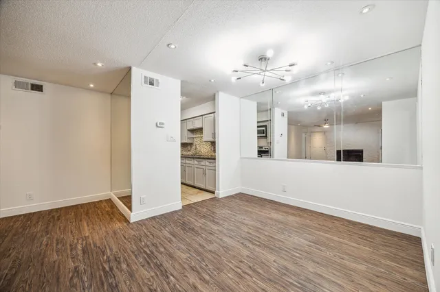 a view of a kitchen with a sink and a refrigerator