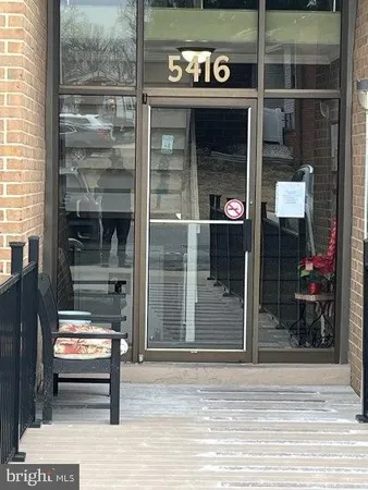 a view of a entrance door of the house and a window