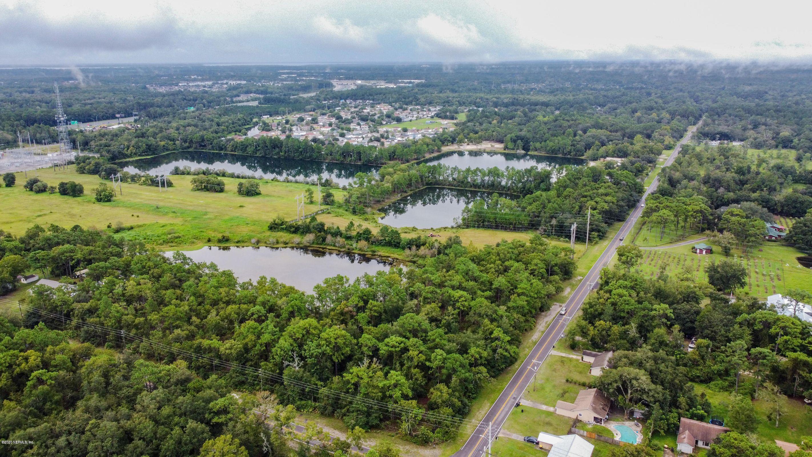 0 Ricker Road Jacksonville, FL 32244 - Photo 3 of 11 an aerial view of residential houses with outdoor space and lake view