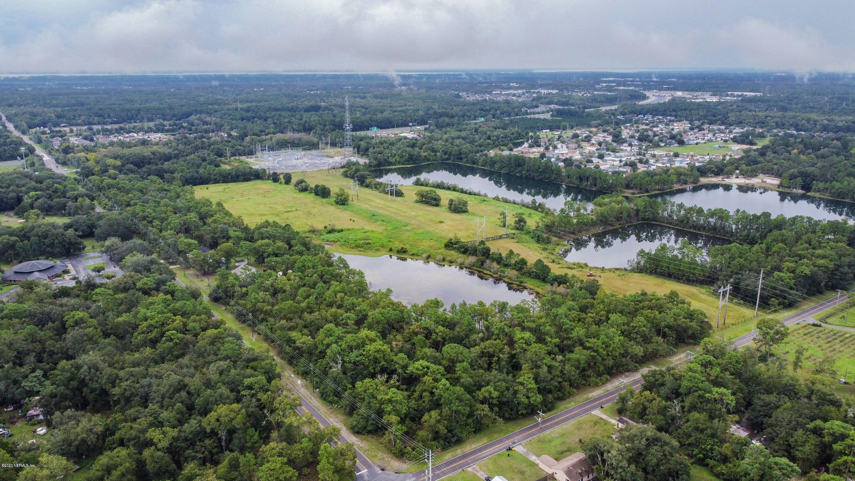 0 Ricker Road Jacksonville, FL 32244 - Photo 4 of 11 an aerial view of residential houses with outdoor space and lake view