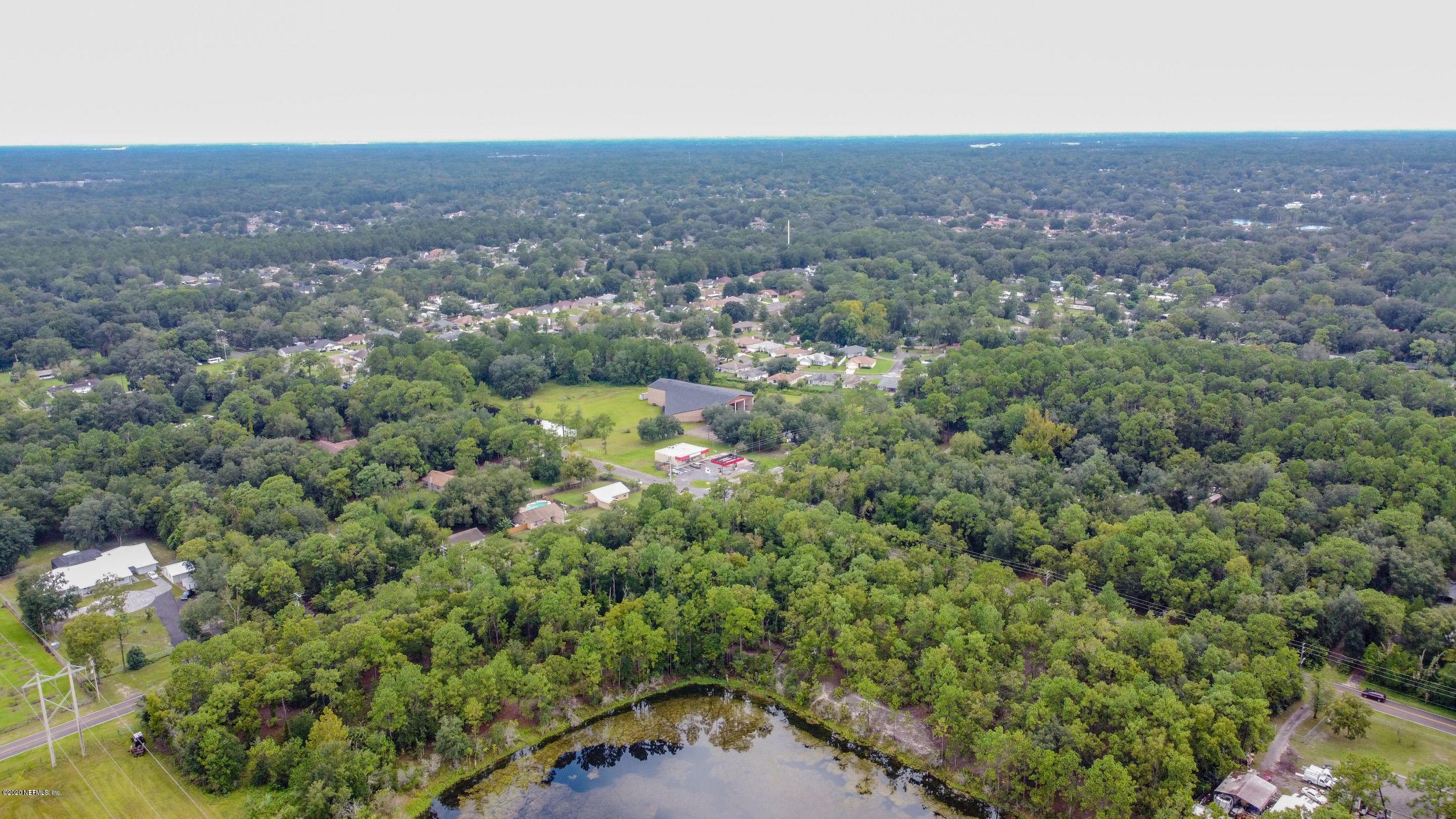 0 Ricker Road Jacksonville, FL 32244 - Photo 5 of 11 an aerial view of residential houses with outdoor space and trees