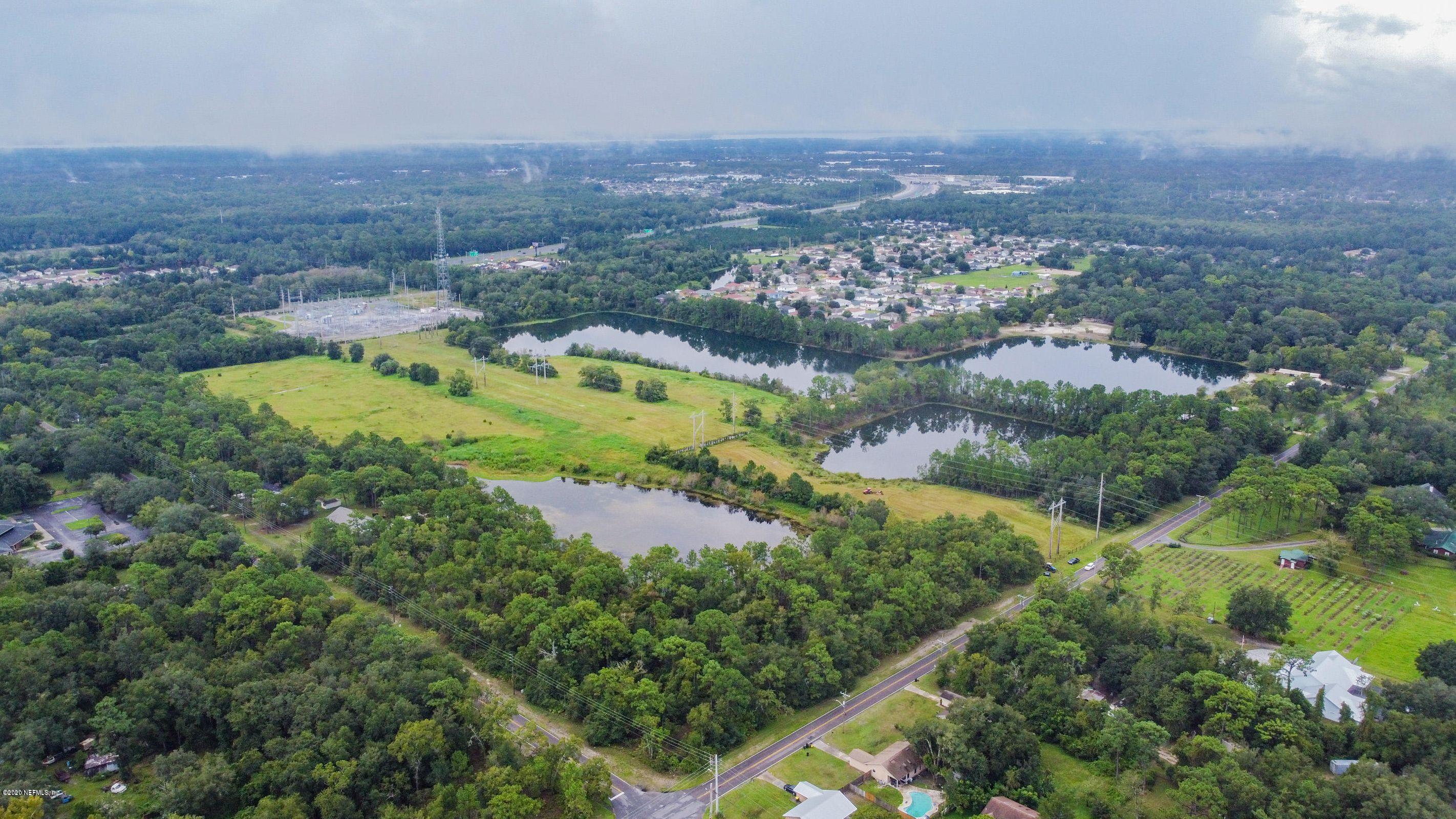 0 Ricker Road Jacksonville, FL 32244 - Photo 8 of 11 an aerial view of residential houses with outdoor space and trees
