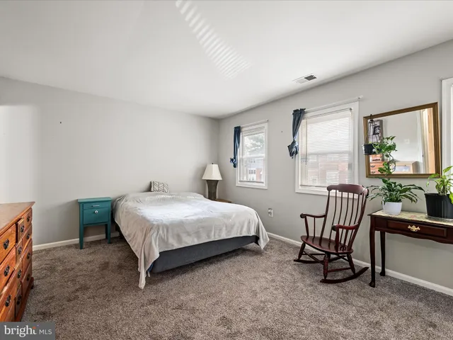 a bedroom with bed and a window