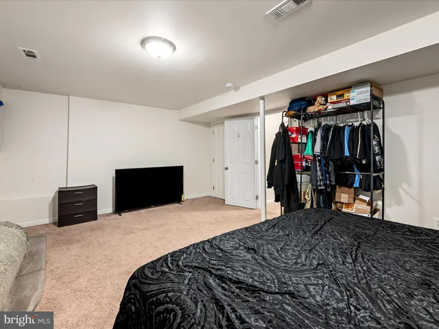 a view of a house with a small yard and a large tree